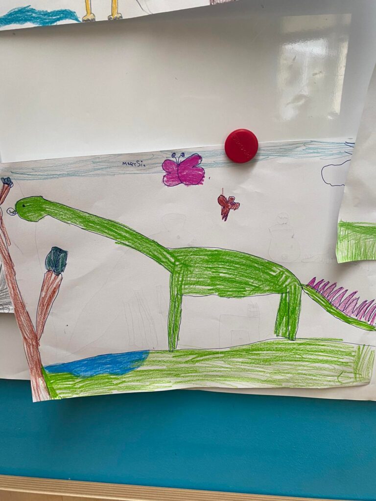 Rysunki dzieci przedstawiające dinozaury.